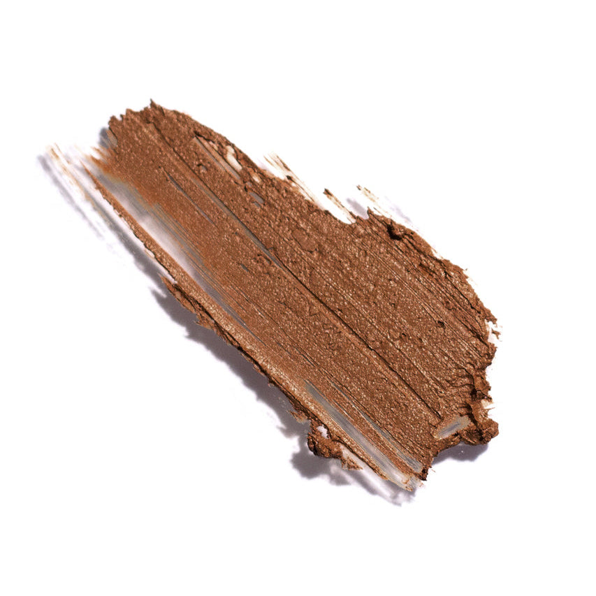 Close-up of a brown makeup swatch on a white background